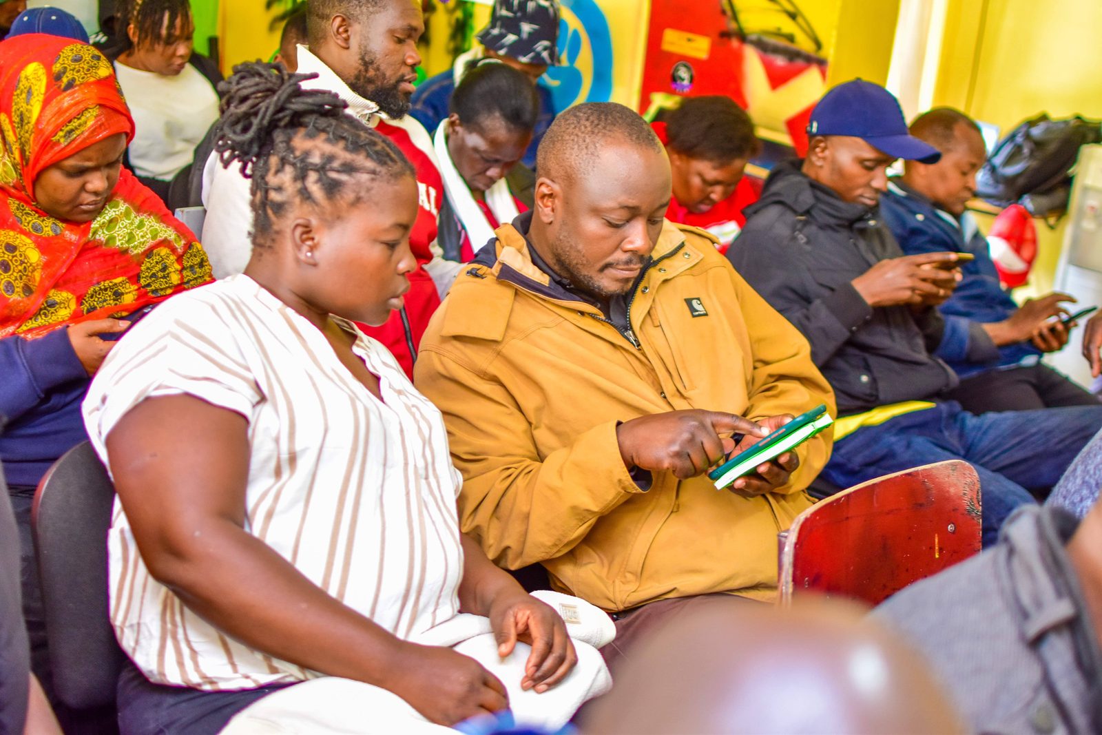 Community members engaging with the Platform together on their phones