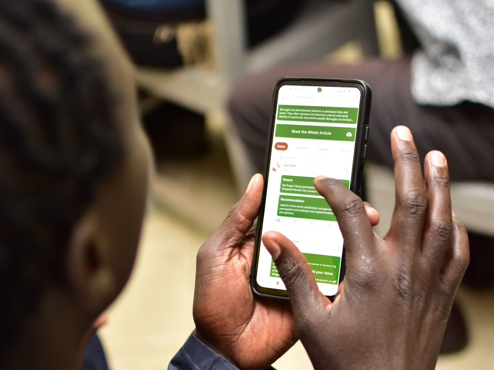 A citizen engaging with the Civic Voices Platform on a mobile phone